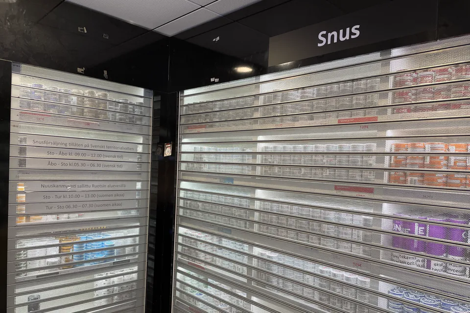 Snus shelves closed off behind metal shutters in a ferry shop while sailing through EU waters