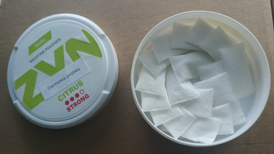 Tobacco-free white nicotine pouches in an open can, the legal UK alternative to snus