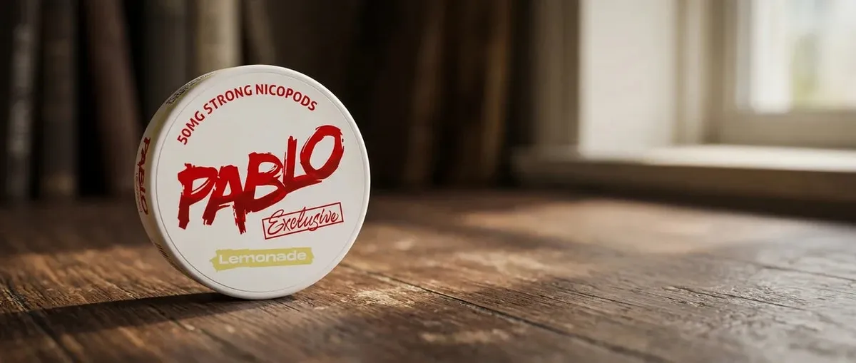 Pablo Exclusive Lemonade 50mg nicotine pouch can standing on a wooden table by a sunlit window