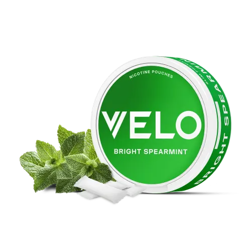 VELO Bright Spearmint nicotine pouches can in green, shown with fresh spearmint leaves and slim white tobacco-free pouches