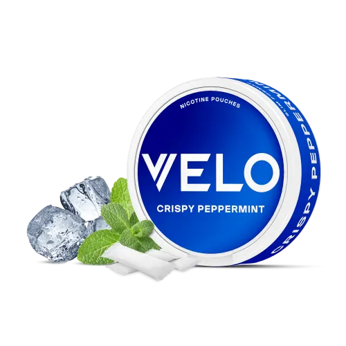 VELO Crispy Peppermint nicotine pouches can in blue, shown with ice cubes, fresh mint leaves and slim white tobacco-free pouches