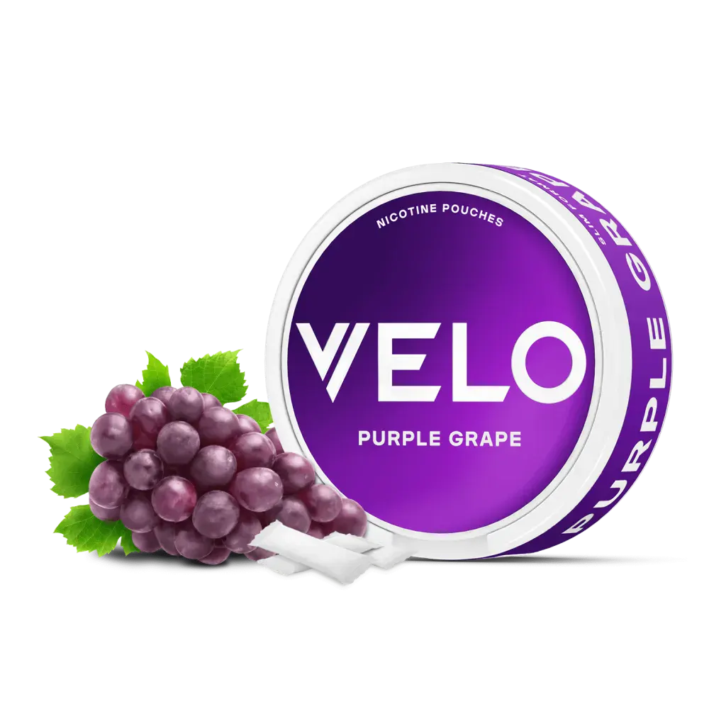 Official VELO Purple Grape nicotine pouches slim can beside a bunch of red grapes and white slim pouches