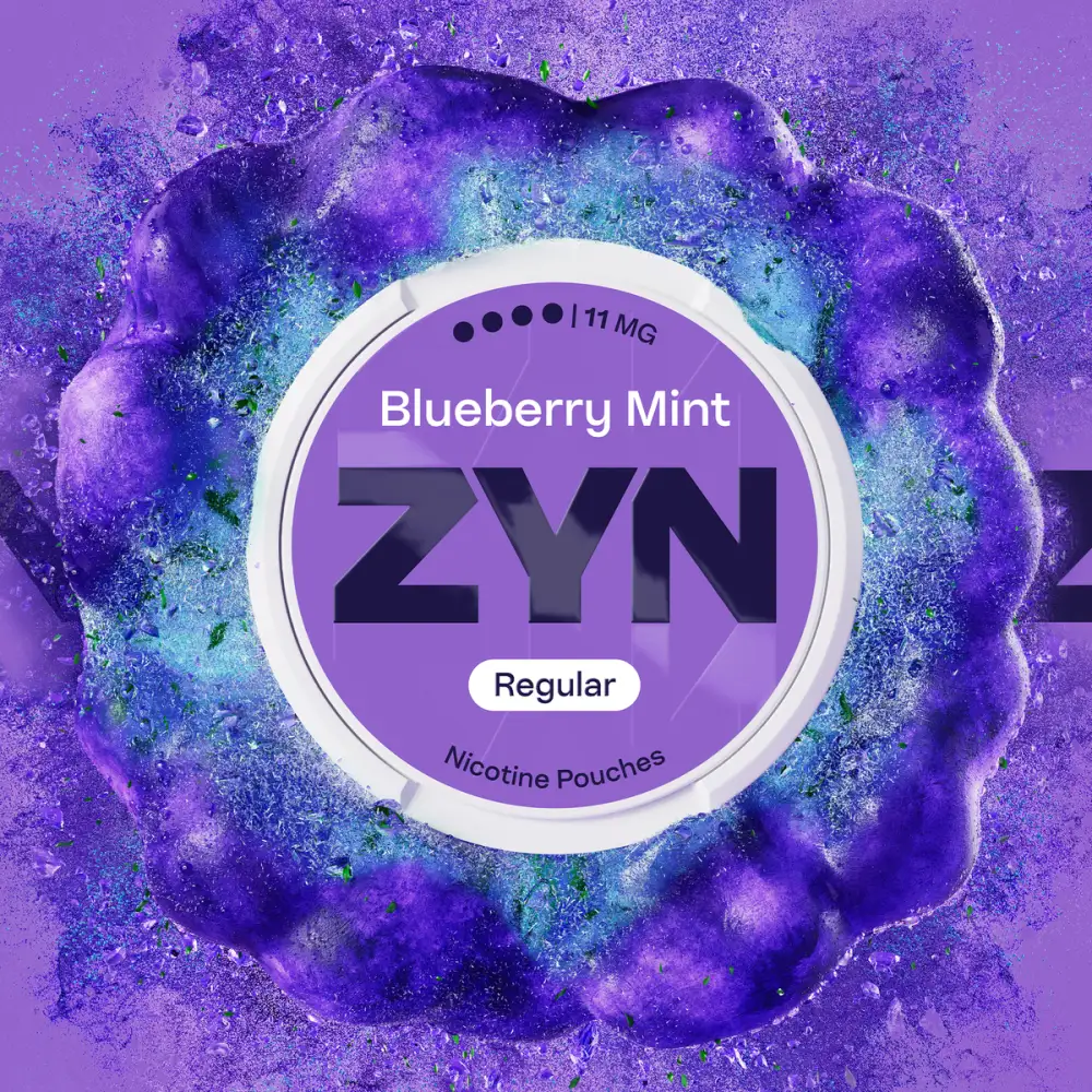 Official ZYN Blueberry Mint nicotine pouches Regular 11mg can on a purple blueberry burst