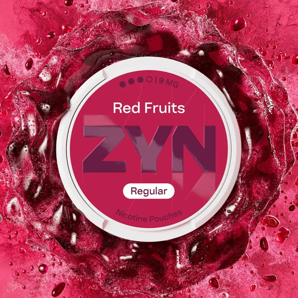 Official ZYN Red Fruits nicotine pouches Regular 9mg can on a deep red berry splash